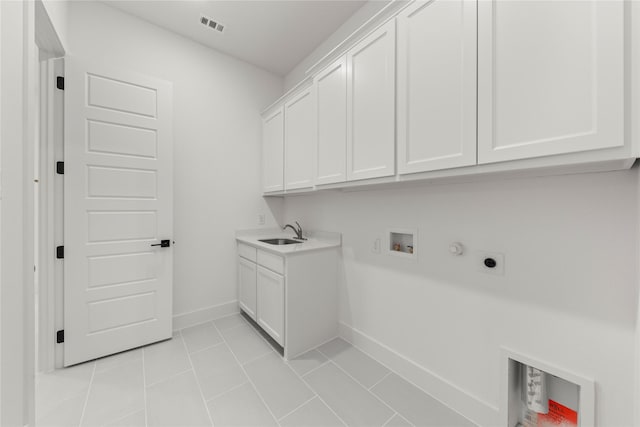 laundry area featuring sink, cabinets, washer hookup, light tile patterned floors, and hookup for an electric dryer