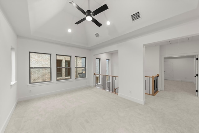 carpeted empty room featuring plenty of natural light, high vaulted ceiling, and ceiling fan