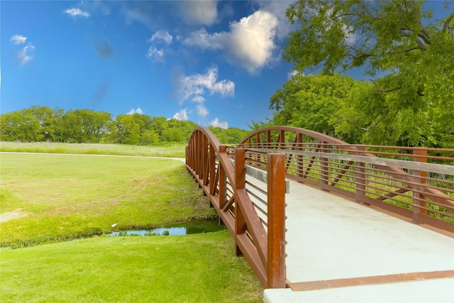 exterior space with a water view and a lawn