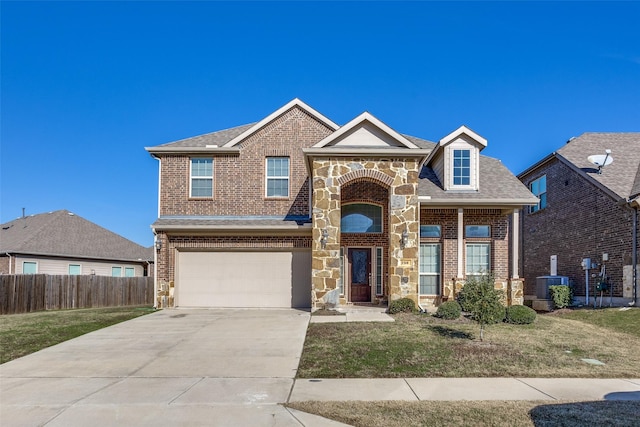 view of front of house with a front yard, a garage, and central AC unit