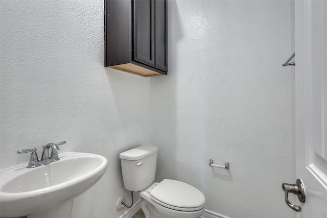 bathroom featuring toilet and sink