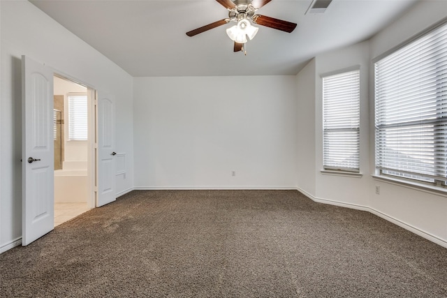 carpeted spare room featuring ceiling fan