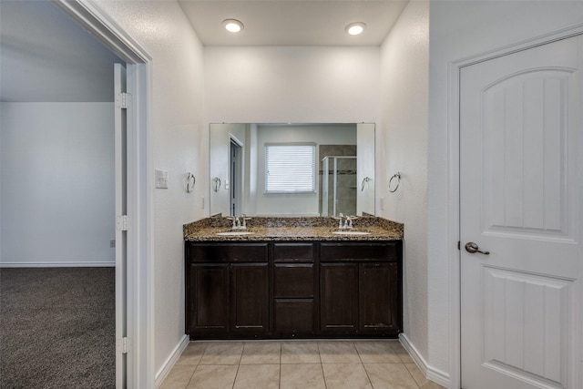 bathroom with tile patterned floors, vanity, and walk in shower