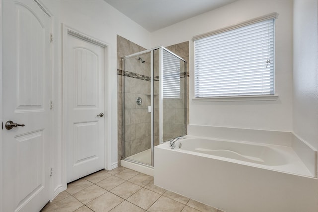 bathroom featuring tile patterned flooring and independent shower and bath