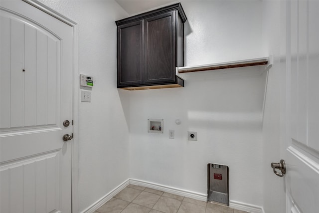 laundry area featuring cabinets, hookup for an electric dryer, gas dryer hookup, hookup for a washing machine, and light tile patterned floors