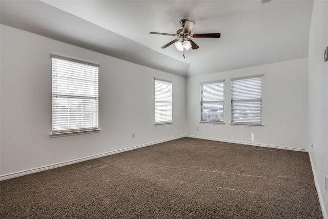 carpeted spare room featuring plenty of natural light and ceiling fan