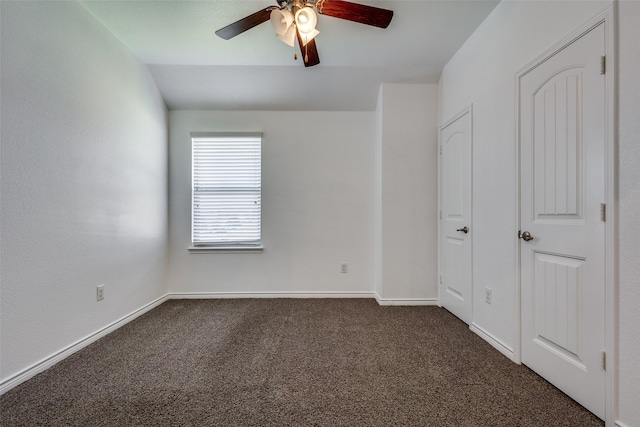 unfurnished bedroom featuring ceiling fan and dark carpet