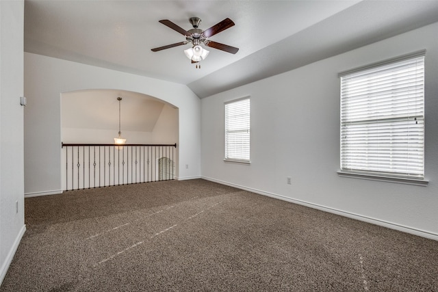 empty room with carpet, ceiling fan, and vaulted ceiling