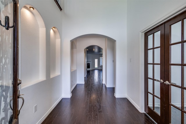 hallway featuring french doors and dark wood-type flooring