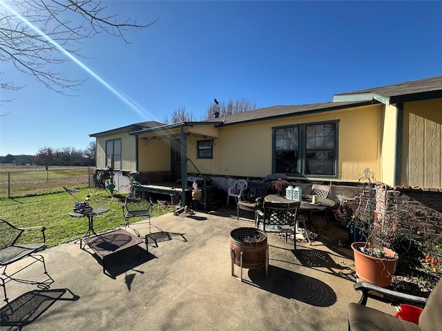 back of house with a lawn and a patio area