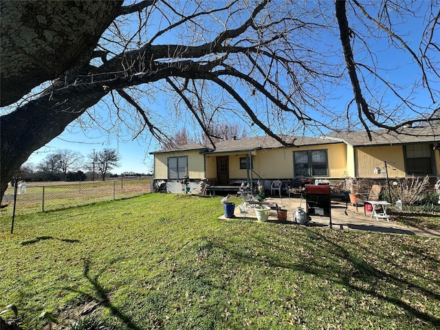 back of property featuring a patio area and a yard