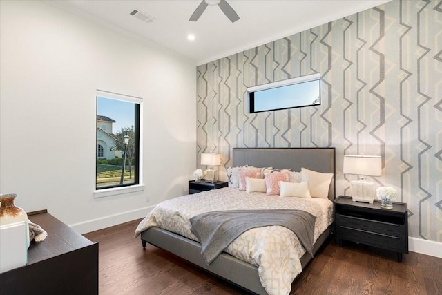 bedroom featuring ceiling fan, dark hardwood / wood-style floors, and crown molding