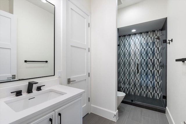 bathroom featuring vanity, toilet, and walk in shower