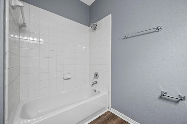 bathroom featuring tiled shower / bath combo and hardwood / wood-style floors