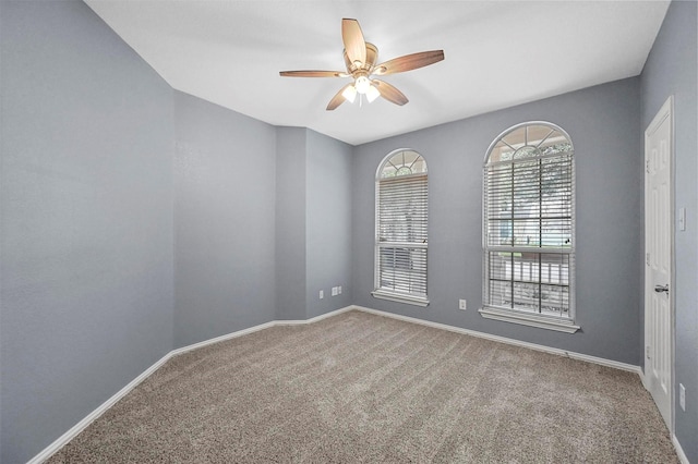 empty room with carpet and ceiling fan