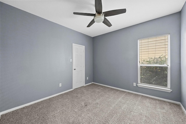 unfurnished room featuring ceiling fan and carpet flooring