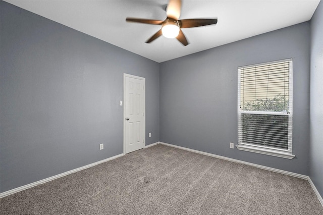 spare room featuring ceiling fan and carpet floors