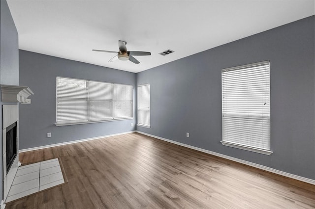 unfurnished living room with light hardwood / wood-style flooring and ceiling fan