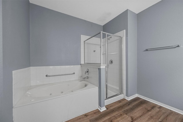 bathroom featuring shower with separate bathtub and hardwood / wood-style floors