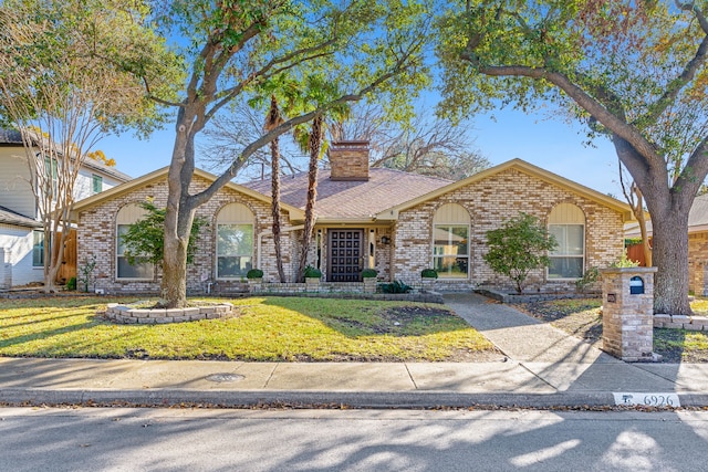 single story home featuring a front lawn