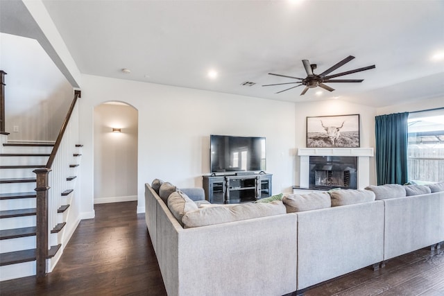 living room with lofted ceiling, dark wood-type flooring, and ceiling fan