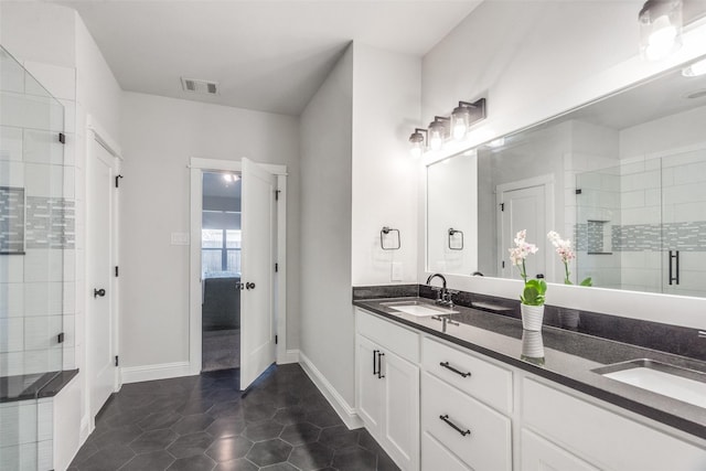 bathroom featuring tile patterned flooring, vanity, and walk in shower