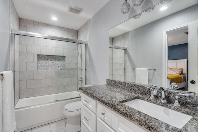 full bathroom with shower / bath combination with glass door, vanity, and toilet