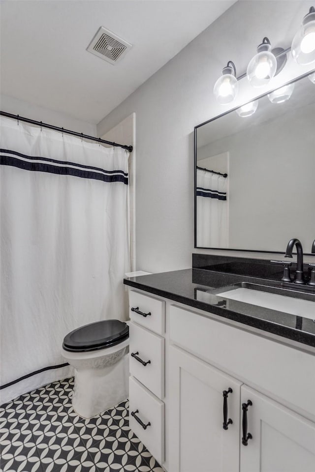 bathroom with vanity and toilet