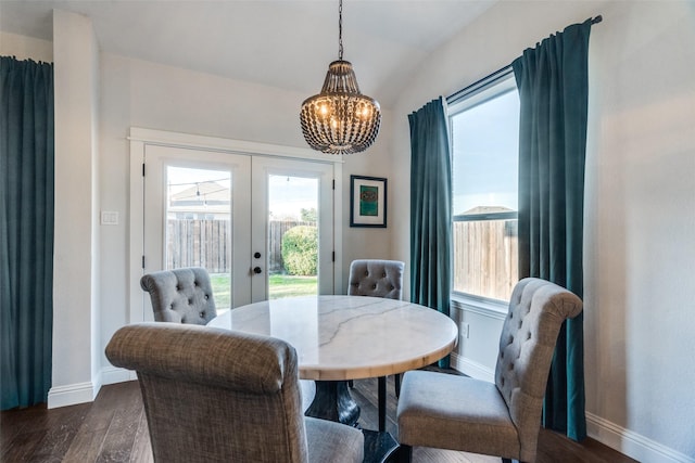 dining space featuring french doors, a chandelier, and dark hardwood / wood-style floors