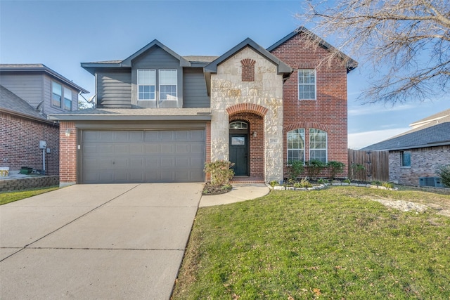 view of property with a garage and a front lawn