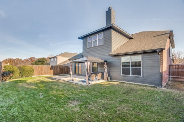 back of house with a gazebo, a yard, and a patio