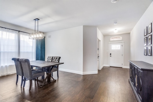 dining space featuring a wealth of natural light and dark hardwood / wood-style flooring