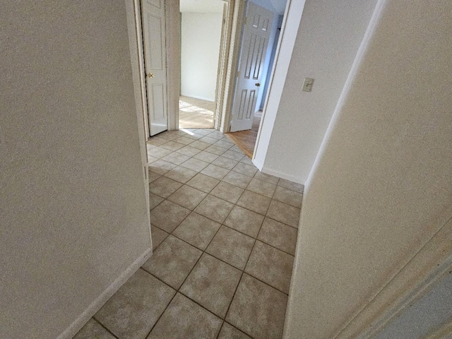 corridor featuring light tile patterned flooring