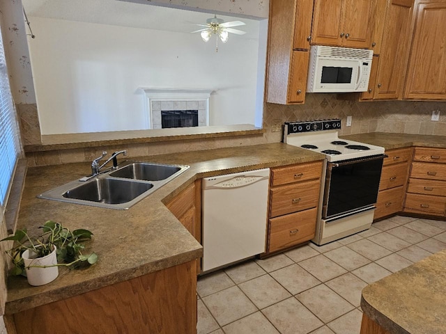 kitchen with sink, kitchen peninsula, white appliances, decorative backsplash, and light tile patterned floors