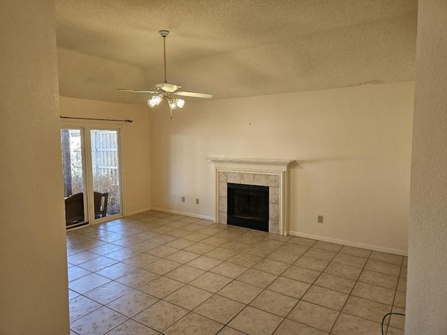 unfurnished living room with a fireplace, light tile patterned floors, a textured ceiling, and ceiling fan