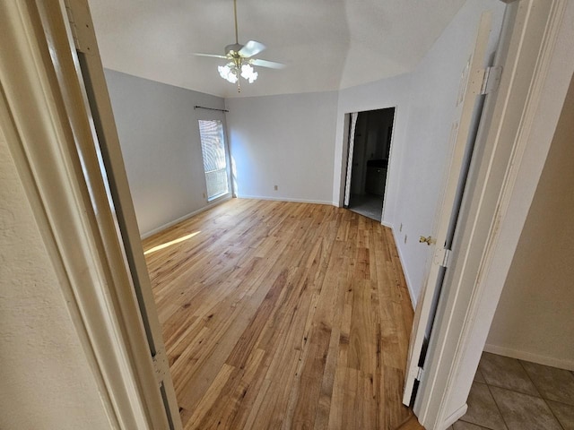 empty room featuring ceiling fan and light hardwood / wood-style flooring