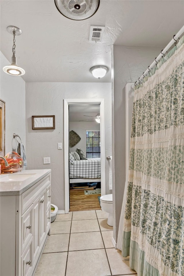 3075 Clark Ln, Paris, TX 75460 - bathroom featuring vanity, tile patterned flooring, ensuite bath, curtained shower, and ceiling fan