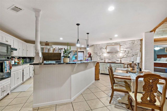 3075 Clark Ln, Paris, TX 75460 - kitchen with oven, light tile patterned floors, a kitchen island, white cabinets, and backsplash