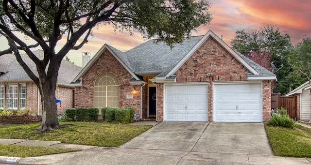 view of front of house featuring a lawn and a garage