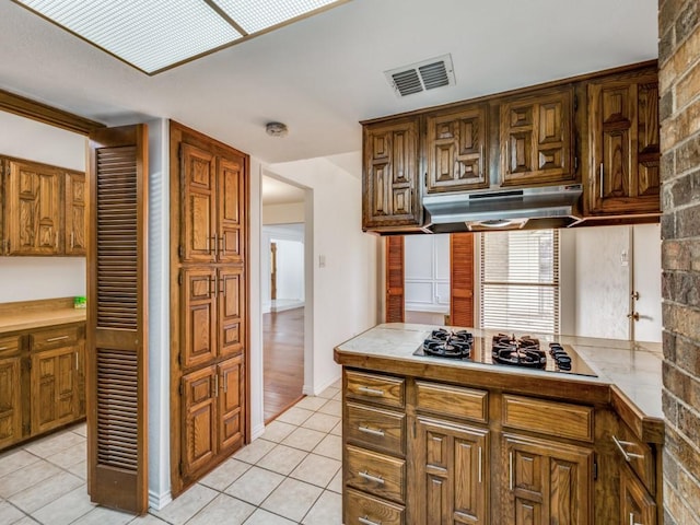 kitchen with stainless steel gas cooktop and light tile patterned flooring