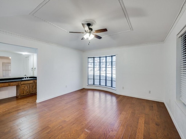 unfurnished room featuring hardwood / wood-style floors, ceiling fan, and crown molding