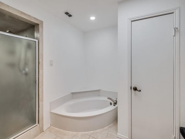 bathroom featuring tile patterned flooring and plus walk in shower