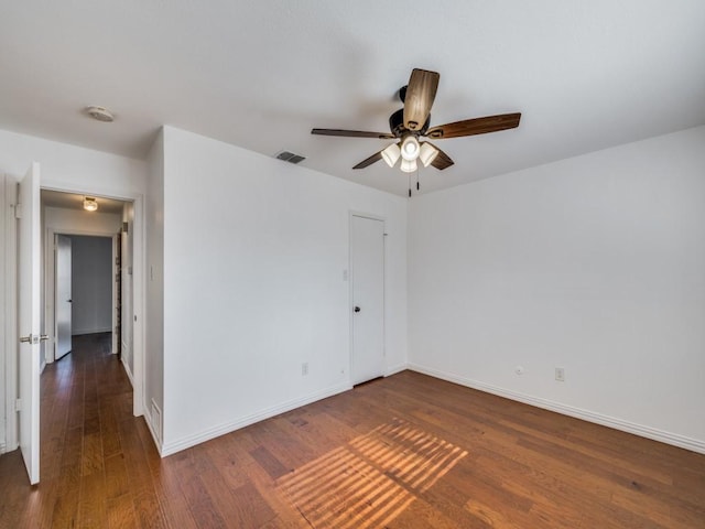 spare room featuring ceiling fan and dark hardwood / wood-style flooring