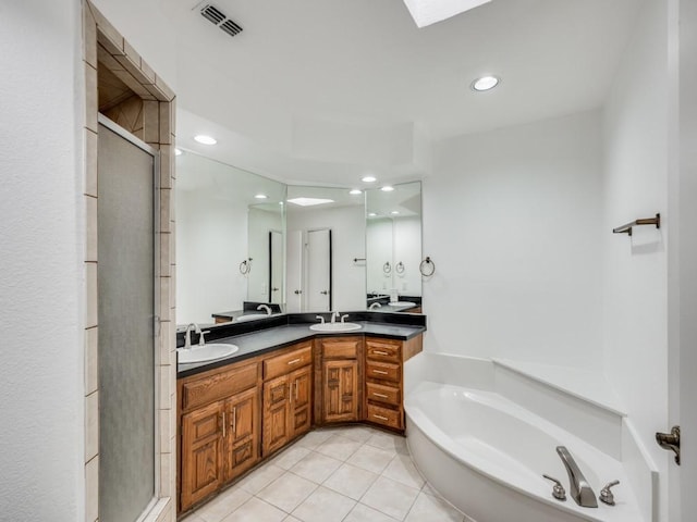 bathroom with tile patterned flooring, vanity, and shower with separate bathtub