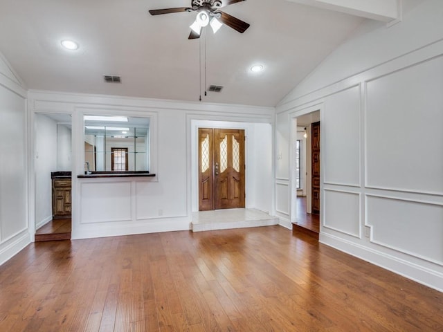 entrance foyer featuring ceiling fan, hardwood / wood-style floors, and vaulted ceiling