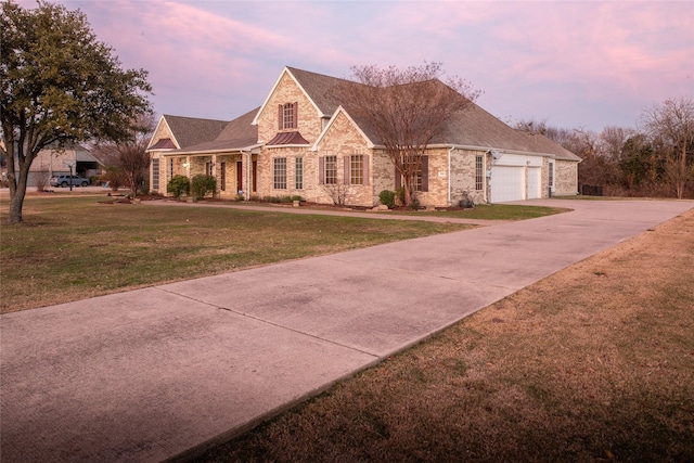 view of front of house featuring a garage and a yard