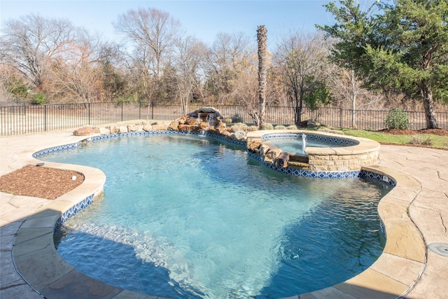 view of pool with pool water feature and an in ground hot tub