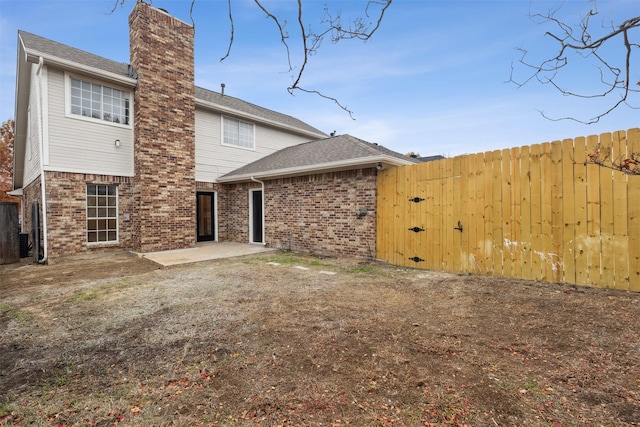 rear view of property featuring central AC unit