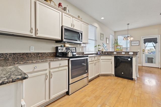 kitchen with white cabinets, hanging light fixtures, appliances with stainless steel finishes, a notable chandelier, and light hardwood / wood-style floors