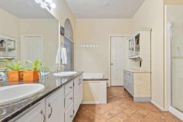 bathroom featuring vanity and a shower with door